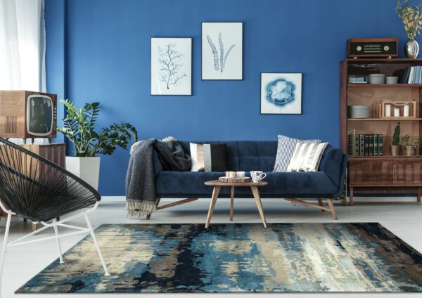 Blue up-to-date decor of lounge with blue sofa and patterned carpet