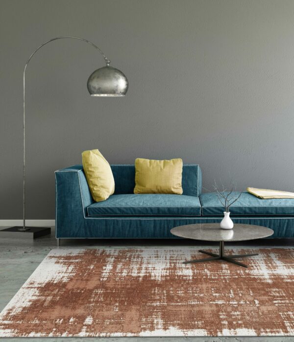 Interior scene with pastel colored sofa with colorful pillows, blank wall for copy space. Modern interior template for copy space. Floor lamp, carpet and coffee table with  vase.
